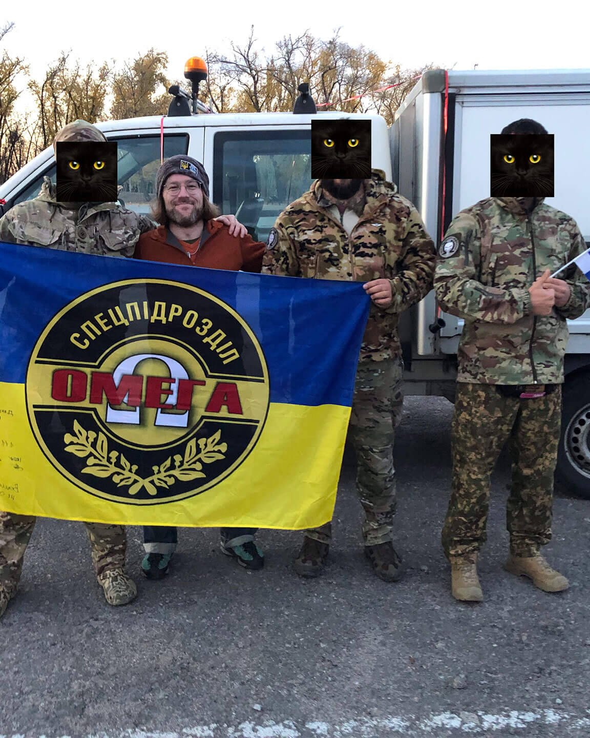 Feeniksin Kilta ry:n puheenjohtaja Markus Mattsson yhdessä erikoisyksikkö Omegan edustajien kanssa. Taustalla Omegalle lahjoitettu ajoneuvo